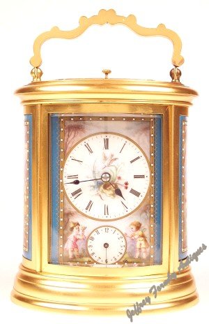 Oval French carriage clock with porcelain panels c1875